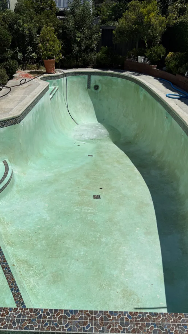 Pool surface during professional acid-wash cleaning in Huntington Beach, CA