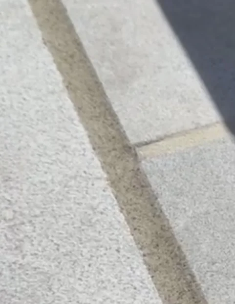 Pool deck expansion joint with new sealant after restoration in Newport Beach, CA