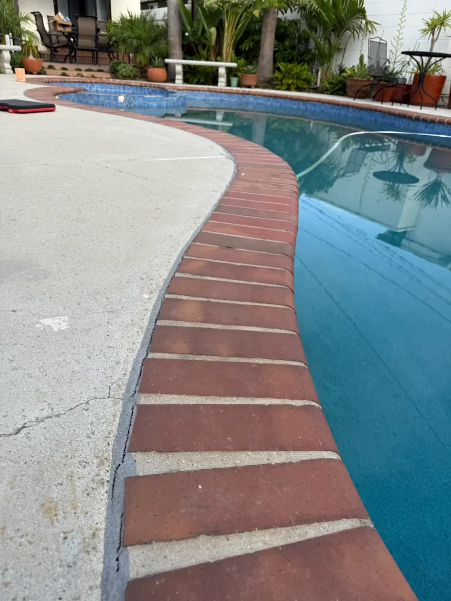 Pool deck seal in need of repair before restoration in Huntington Beach, CA